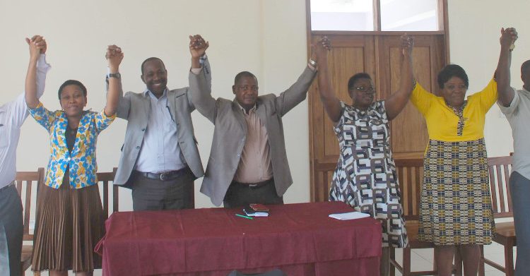 Picture of Stakeholders from Lushoto district DC, MAFC, VPO, IITA and PMO -RALG holding hands at the launching of the Lushoto district climate change Learning Alliance