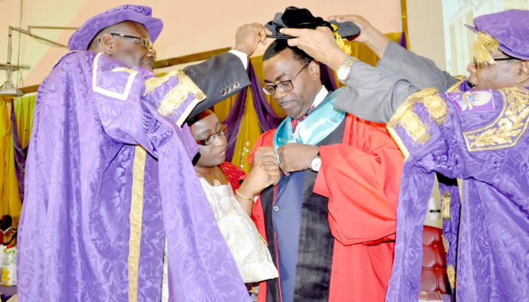 Picture of Dr Akinwumi Adesina receiving his cap and gown during the conferment ceremony.