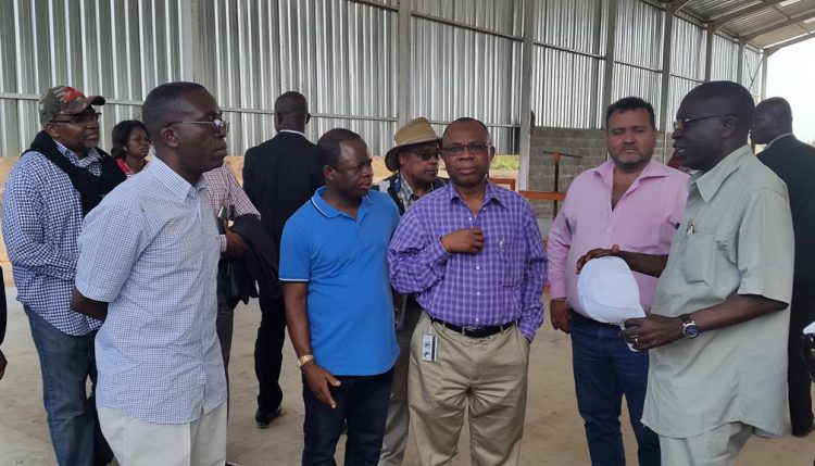 Picture of Chiji Ojukwu of AfDB (center) and H.E. Matata Ponyo (left) listen to IITA’s Nzola Mahungu (right), IITA Representative in DR Congo, talking about the cassava processing equipment introduced through the SARD-SC project funded by AfDB.