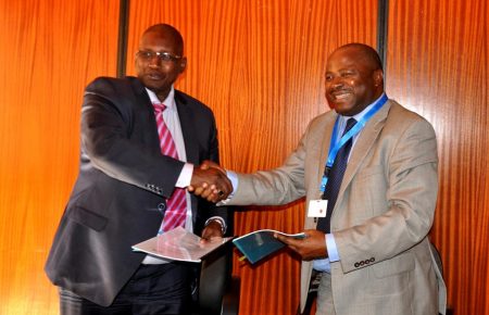 Picture of DGs Kireger (KALRO) and Sanginga shaking hands after the signing.