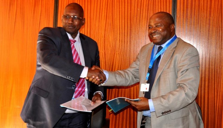 Picture of DGs Kireger (KALRO) and Sanginga shaking hands after the signing.