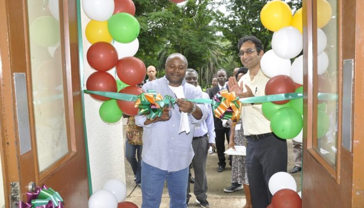 Picture of DG Sanginga cutting the ribbon during the commissioning of the BASICS office, in IITA,Ibadan, with BASICS project coordinator Hemant Nitturkar.