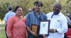 Picture of Lava Kumar (center) poses with his plaque flanked by DG Sanginga (right) and spouse Ranjana Bhattacharjee (left).