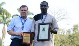Picture of Idowu Ifaturoti with BOT Chair Bruce Coulman (left) displays his outstanding support staff award plaque.