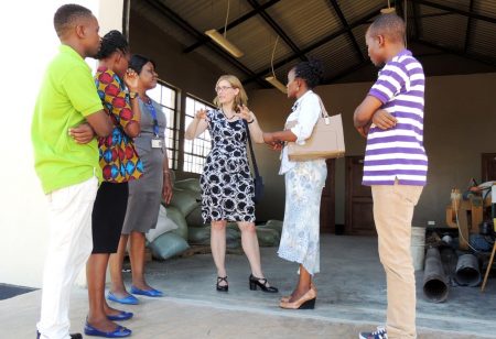 Picture of Hilde (middle) interacting with some staff members during her tour of the facilities in Tanzania.