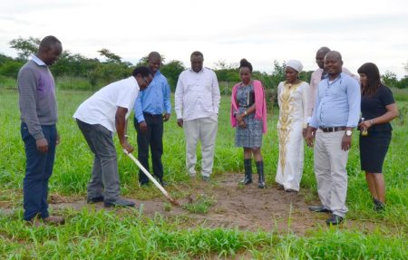 Picture of Chikoye breaking ground at the future site of the maize seed storage and warehouse facility at SARAH campus as IITA staff and construction representatives look on.