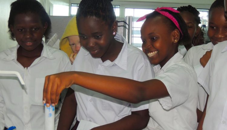 Picture of students getting an opportunity to use scientific equipment in the labs.