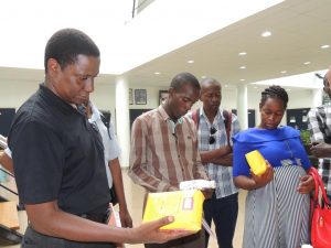 Picture of Media having a feel of IITA’s products during the Media familiarization event.