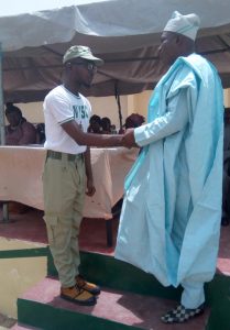 Picture of FCT State Coordinator recognizing Azeez as the most outstanding corper.