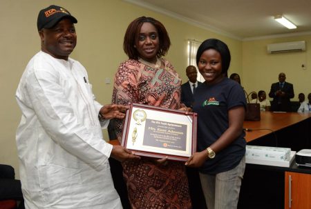 Picture of DG Sanginga and an Agripreneur presents a plaque to HE, Kemi Adeosun.