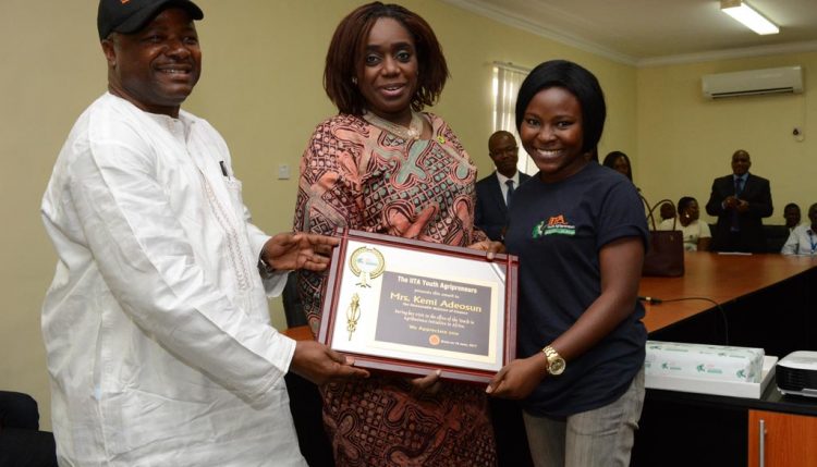 Picture of DG Sanginga and an Agripreneur presents a plaque to HE, Kemi Adeosun.