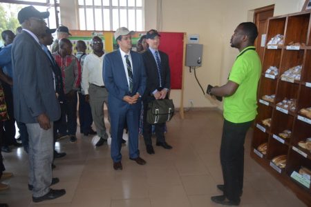 Picture of Christopher Tocco (center) with other USAID delegates and event participants at the youth Agripreneurs exhibition center.