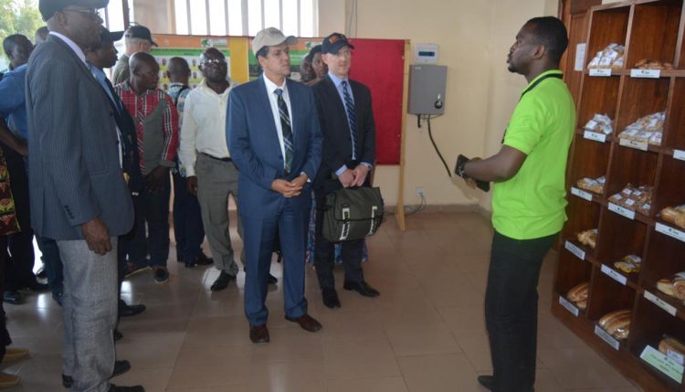 Picture of Christopher Tocco (center) with other USAID delegates and event participants at the youth Agripreneurs exhibition center.