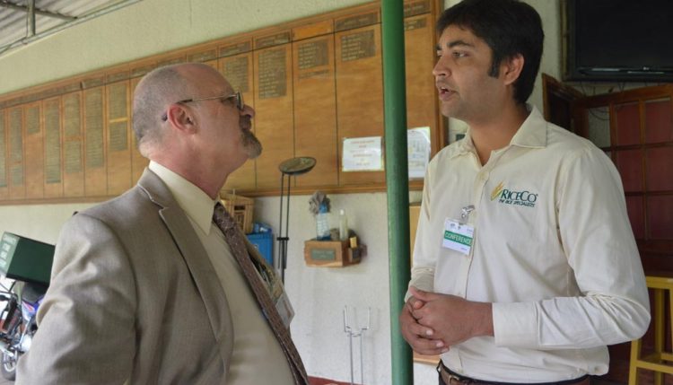 Picture of Dr Ken Dashiell (left) speaking to Shanni Srivastava of UPL, an agrochemical company.