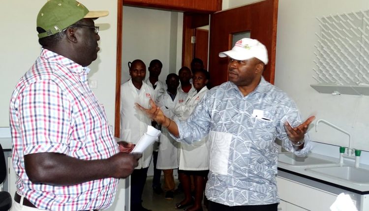 Picture of DG and Lawrence Kaptoge discussing the progress of construction during the visit.