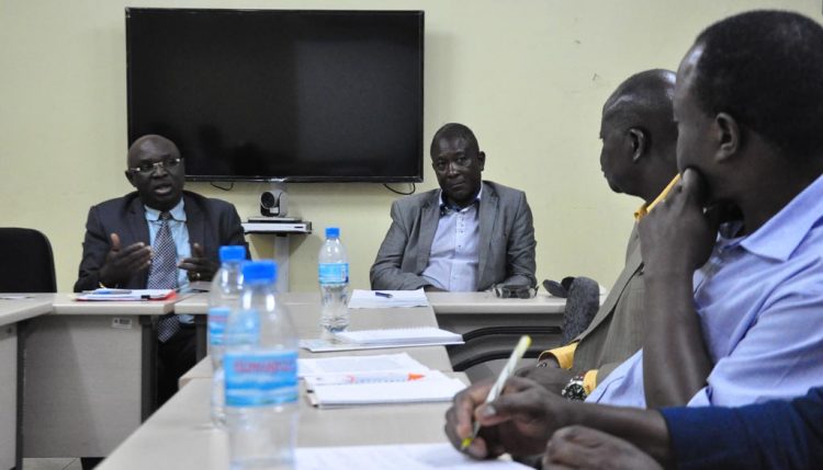 Picture of the Permanent Secretary (left) and his team members briefing the IITA delegation.