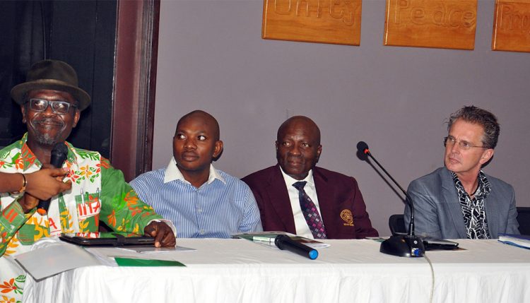 Attah-Krah (left) speaking at the meeting.