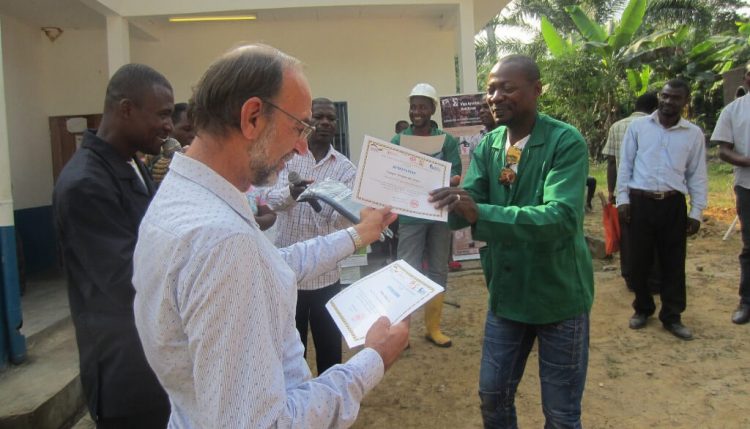 Picture of A farmer receiving a certificate during the graduation after a series of farmers field school training by PROSICA in Cameroon.