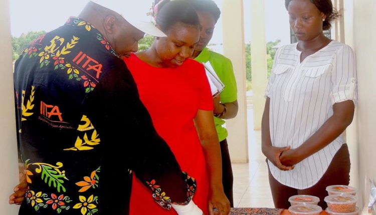 Picture of Youth Agripreneurs showcase some of their products to the DG (left)