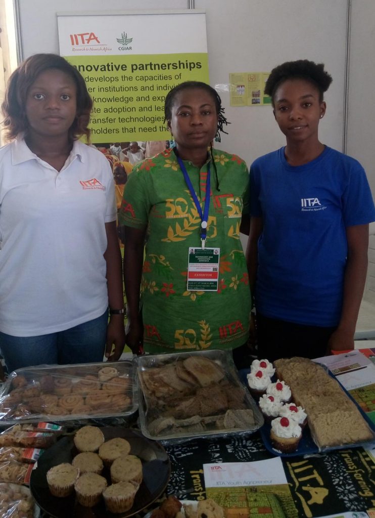 Picture of IITA staff showcasing value-added products from cassava and yam