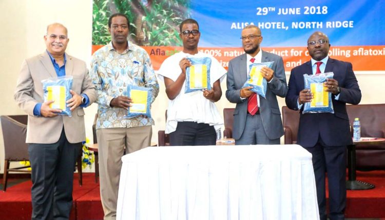 Picture of Research Leader of the Africa-wide Aflasafe Initiative at IITA, Ranajit Bandyopadhyay (left),with Abdou Konlambigue of ATTC (rightmost) and other dignitaries showing off packs of Aflasafe GH02 at its launch in Accra.