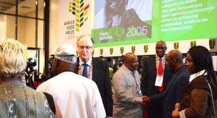 Picture of DG Nteranya Sanginga being congratulated by AGRF participants