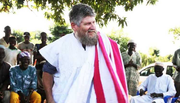 Picture of Farmers in Cheyohi Community in the Northern Region of Ghana ceremonially dressed Jerry Glover in the traditional Ghanaian smock