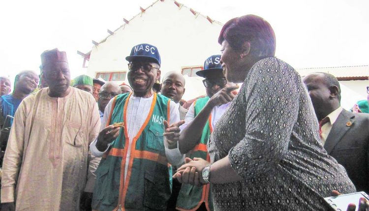 Picture of Hon. Minister of Agriculture and Rural Development, Chief Audu Ogbeh eating bread made from yam composite flour