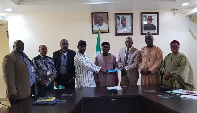 IITA team with Minister of Agriculture, Chief Audu Ogbeh (center) and officials of Origin Group Nigeria at the signing ceremony.