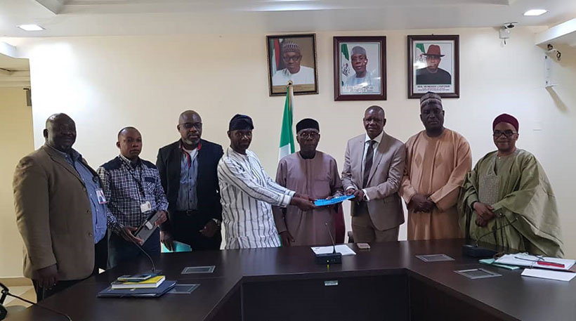 IITA team with Minister of Agriculture, Chief Audu Ogbeh (center) and officials of Origin Group Nigeria at the signing ceremony.