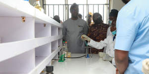 Governor Seyi Makinde with a student of Methodist High School in the Central laboratory.