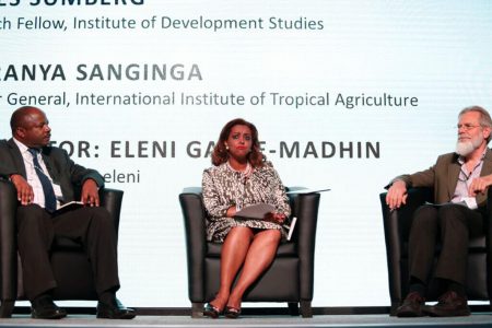 Picture of DG Nteranya Sanginga (left) on the debate floor with Eleni Gabre-Madhin (moderator) and Jim Sumberg (right)