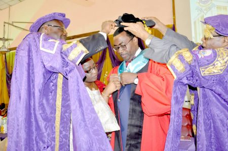 Picture of Dr Akinwumi Adesina receiving his cap and gown during the conferment ceremony.