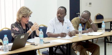 Picture of World Bank’s Sara Simons giving an overview of funding opportunities in Tanzania as IITA’s Freddy Baijukya and Victor Manyong listen intently