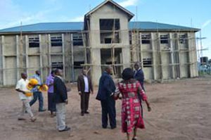 Picture of Tarawali leading the visitors to the Youth Training Center and Agripreneurs’ Work Station that is under construction.