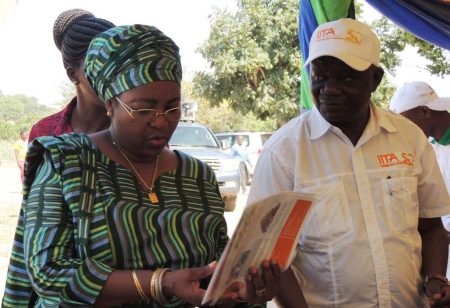 Picture of Victor Manyong explaining to the former first lady, Salma Kikwete, IITA’s research on aflasafe, an effective biocontrol agent for reducing aflatoxin contamination.