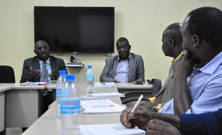 Picture of the Permanent Secretary (left) and his team members briefing the IITA delegation.