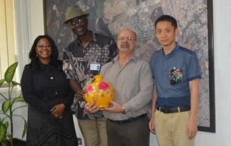 Picture of Special adviser to Oyo State Governor on project and bureau of investment promotions Tolu Sadipe (left), and one of the Chinese investors (right) presenting a souvenir to IITA management.
