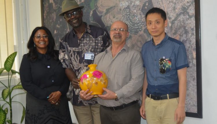 Picture of Special adviser to Oyo State Governor on project and bureau of investment promotions Tolu Sadipe (left), and one of the Chinese investors (right) presenting a souvenir to IITA management.