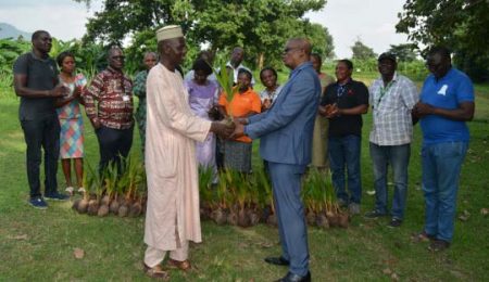 Picture of Mallam Aminu Abubakar of FCTA presenting the coconut trees to the Head of Abuja Station, Dr Gbassey Tarawali