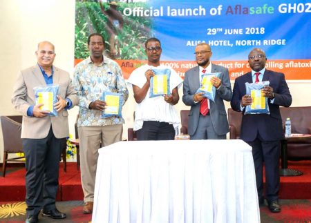 Picture of Research Leader of the Africa-wide Aflasafe Initiative at IITA, Ranajit Bandyopadhyay (left),with Abdou Konlambigue of ATTC (rightmost) and other dignitaries showing off packs of Aflasafe GH02 at its launch in Accra.