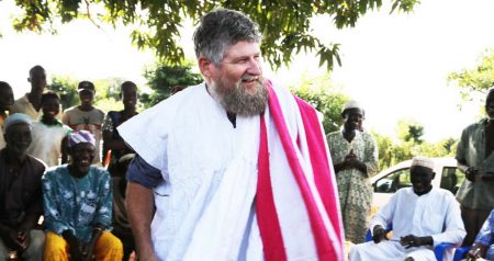 Picture of Farmers in Cheyohi Community in the Northern Region of Ghana ceremonially dressed Jerry Glover in the traditional Ghanaian smock