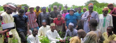 Group photograph of Seed System Specialists and farmers appreciating their high yield