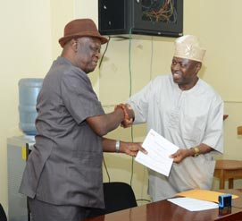 Picture of Alfred Dixon, Director, P4D Office (left), and Owolabi Oladejo, the President and Founder of MBS (right), shaking hands after the MoU signing